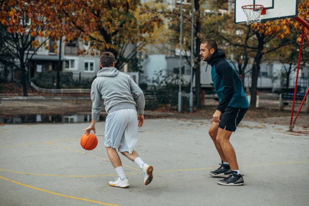 istock Friends playing basketball outside 1356561218