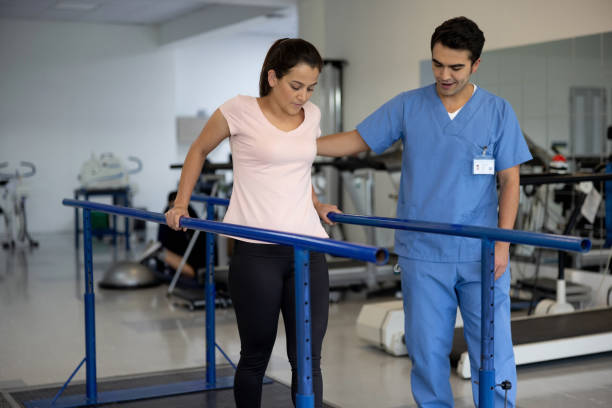 istock Woman in physiotherapy walking on the parallel bars 1356562161