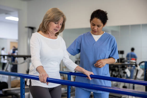 istock Woman in physiotherapy walking on the parallel bars 1356562165