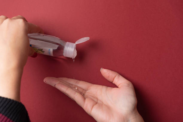Woman hands close up putting gel on fingers stock photo