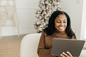 istock Woman with tablet and. Holiday online shopping 1356562353