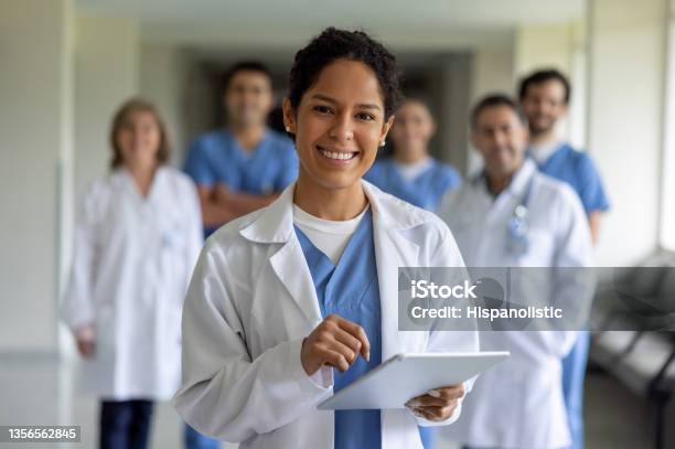 Happy Doctor Leading A Team Of Healthcare Workers At The Hospital Stock Photo - Download Image Now