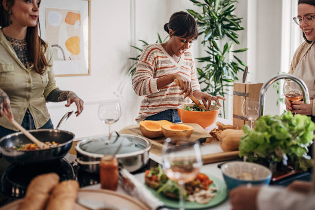 istock Female friends preparing a meal 1356563413