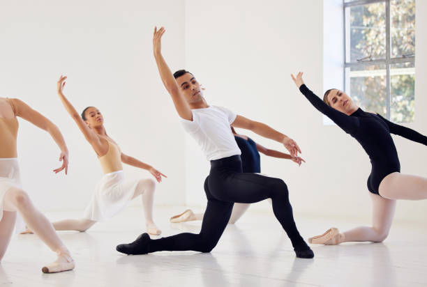 istock Shot of a group of ballet dancers practicing a routine in a dance studio 1356564583