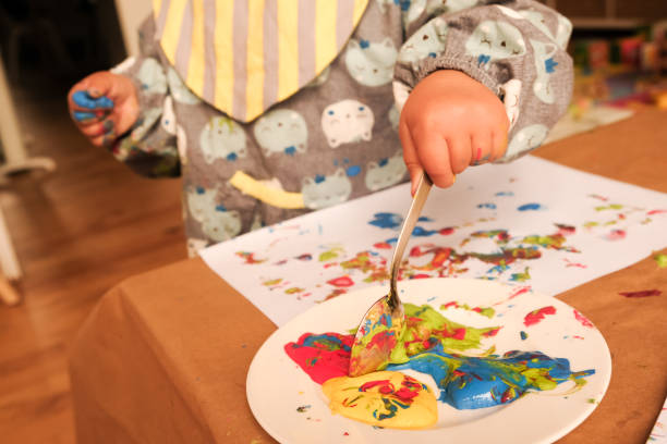 istock Early childhood development activity: finger painting at home 1356566578
