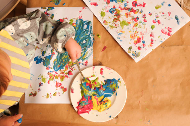 istock Early childhood development activity: finger painting at home 1356566639