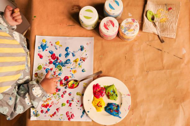 istock Early childhood development activity: finger painting at home 1356566673