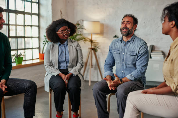 istock Man talking to the mental health support group 1356568358