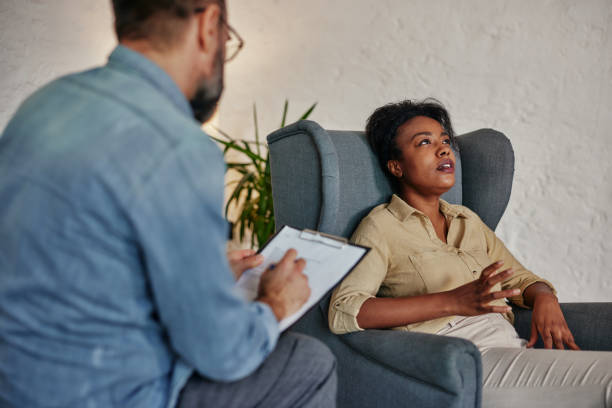 istock Young female client having consultation with psychologist 1356568498