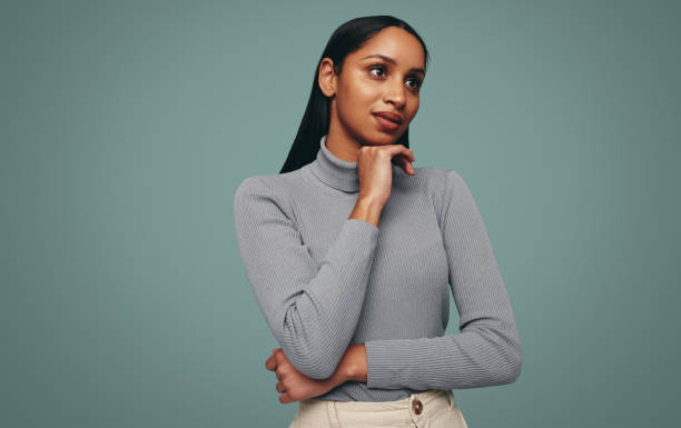 istock Gorgeous young woman looking away in a studio 1356569892