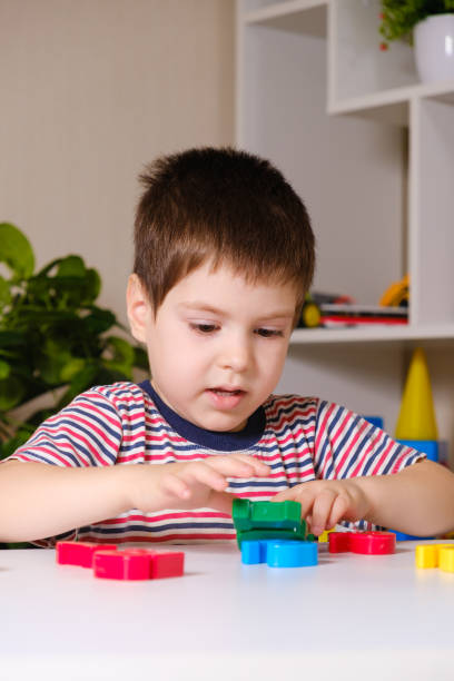 istock A boy of 4 years plays with multi-colored numbers, builds a tower 1356569899