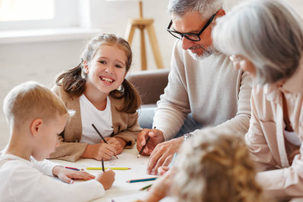 笑顔のシニアカップルの祖父母は、週末に自宅で孫と一緒に時間を過ごす - grandmother child senior adult multi generation family ストックフォトと画像