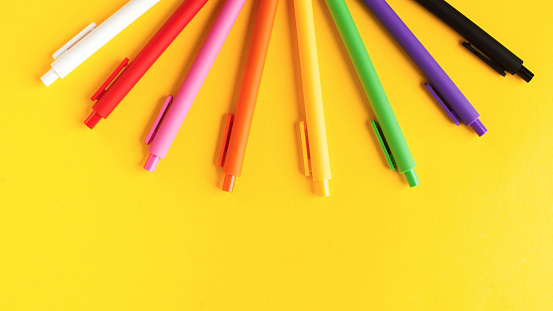 Multi colored pens on a yellow background. Banner. Stationery. High quality photo