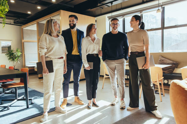 istock Group of colleagues smiling cheerfully in an office 1356570612