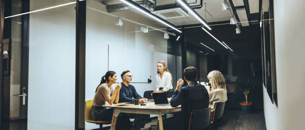 istock Group of colleagues having a meeting in a boardroom 1356570657