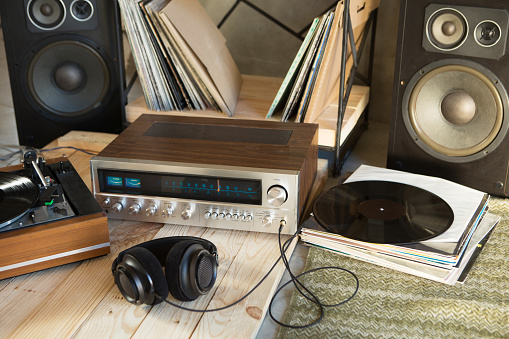 HiFi system with turntable, amplifier, headphones and lp vinyl records in a listening room