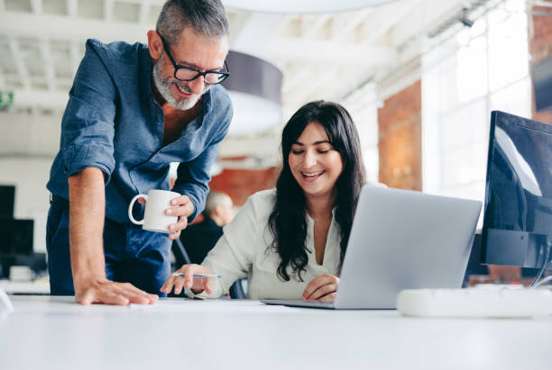 istock Two happy colleagues collaborating on a new project in the offic 1356572377