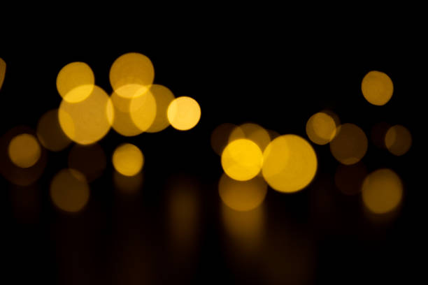 istock Bokeh golden lights on black background 1356572736