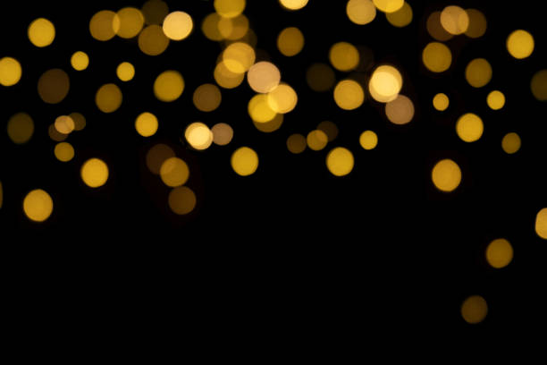 istock Bokeh golden lights on black background 1356572749
