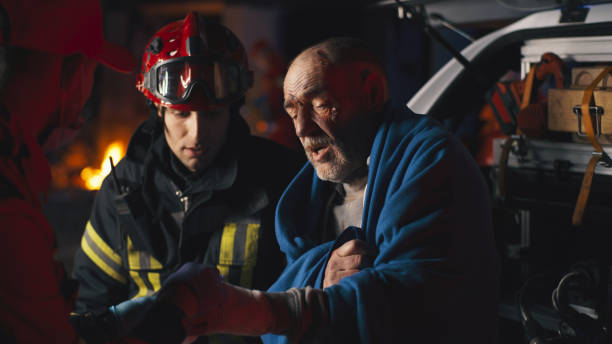 istock Senior survivor speaking to emergency service workers 1356573441