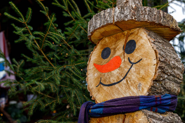 wooden snowman in the garden stock photo
