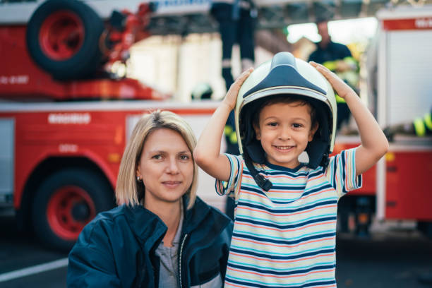 istock Portrait of firefighter and little boy 1356576464