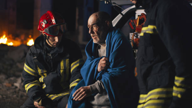 istock Senior survivor speaking to emergency service workers 1356576536