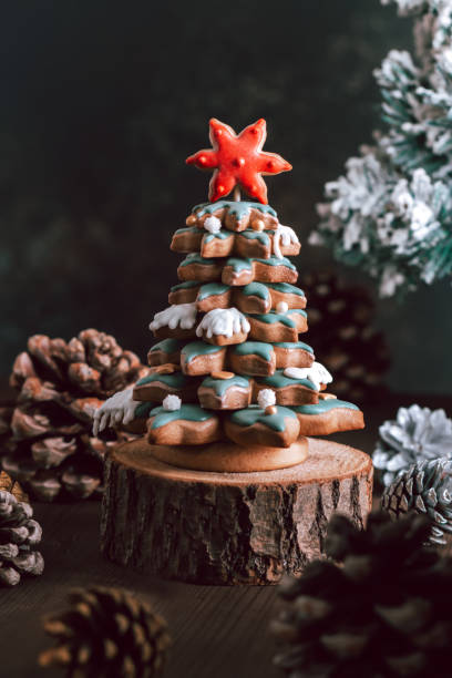 istock Gingerbread Christmas tree on dark table, Christmas card 1356576546