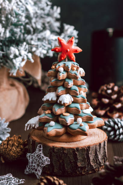istock Gingerbread Christmas tree on dark table, Christmas card 1356576547