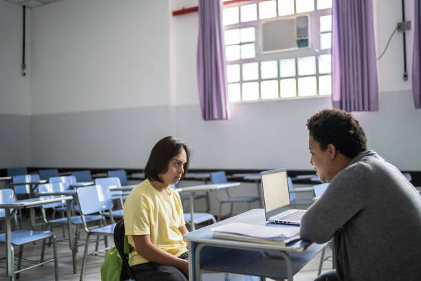 istock Special needs student studying with a teacher in the classroom 1356577897