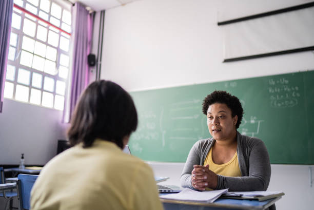 istock Student studying with a teacher in the classroom 1356577933