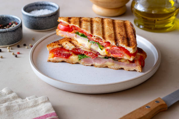 istock Sandwich with ham, tomato, cheese and spinach. Breakfast. Fast food. 1356581228
