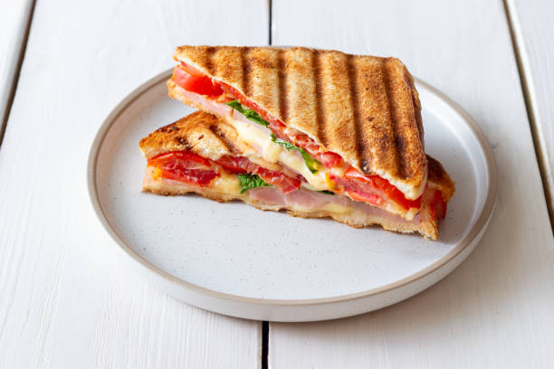istock Sandwich with ham, tomato, cheese and spinach. Breakfast. Fast food. 1356581264