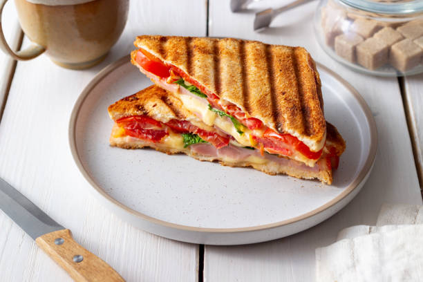 istock Sandwich with ham, tomato, cheese and spinach. Breakfast. Fast food. 1356581286
