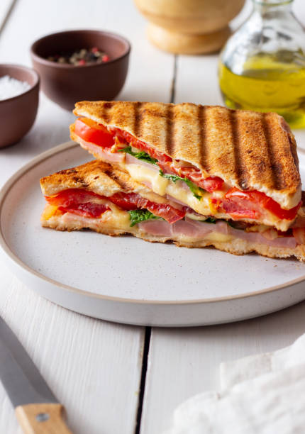 istock Sandwich with ham, tomato, cheese and spinach. Breakfast. Fast food. 1356581309