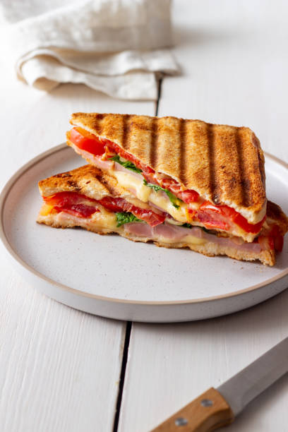 istock Sandwich with ham, tomato, cheese and spinach. Breakfast. Fast food. 1356581331
