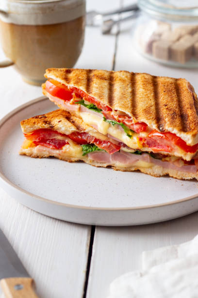 istock Sandwich with ham, tomato, cheese and spinach. Breakfast. Fast food. 1356581351