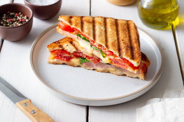 istock Sandwich with ham, tomato, cheese and spinach. Breakfast. Fast food. 1356581372