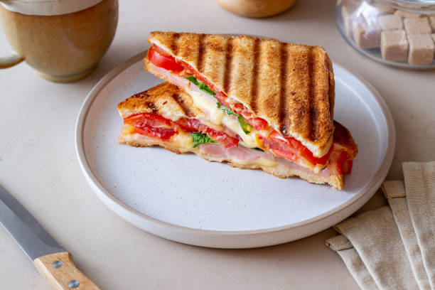 istock Sandwich with ham, tomato, cheese and spinach. Breakfast. Fast food. 1356581384
