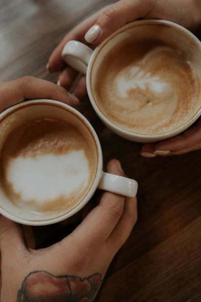 istock Two cups of coffee in hand close-up 1356581644