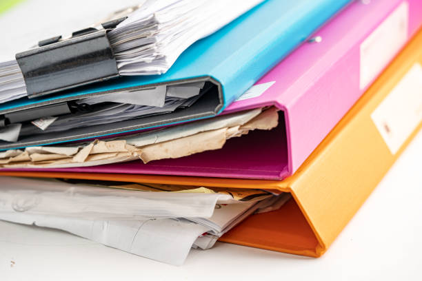 istock File Folder Binder stack of multi color on table in business office. 1356582888