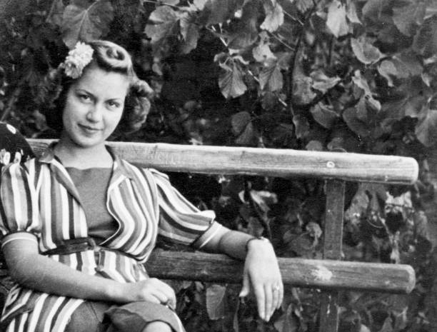 istock Young woman on a Bench in 1938. 1356584312