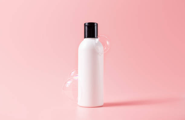istock Shampoo bottle with soapy bubbles. Beauty skincare cosmetic packaging mockup 1356587383