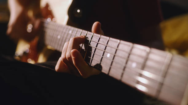 istock Crop teenager practicing to play guitar 1356588054