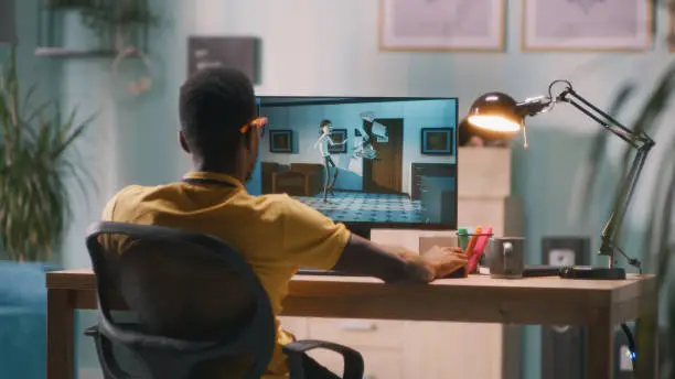 Photo of Man creating 3D cartoon on computer