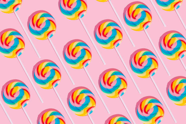 Minimal lollipop pattern on pastel pink background. Sweets, party, childhood and birthday concept. Geometric lollipop pattern on pastel pink background. Sweets, party, childhood and birthday concept. lolipop stock pictures, royalty-free photos & images