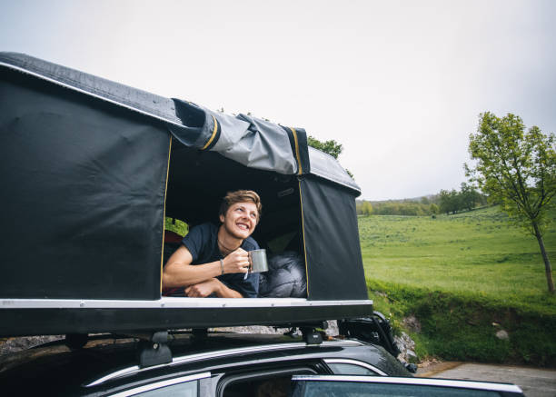 istock Young man enjoys a hot beverage outdoors, mountains 1356591602