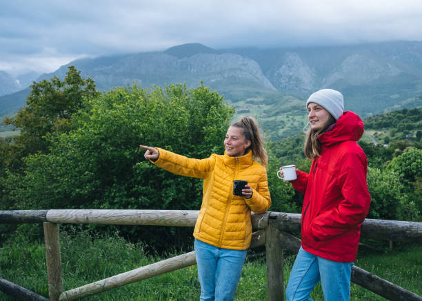 istock Friends enjoy a hot beverage together outside 1356591640