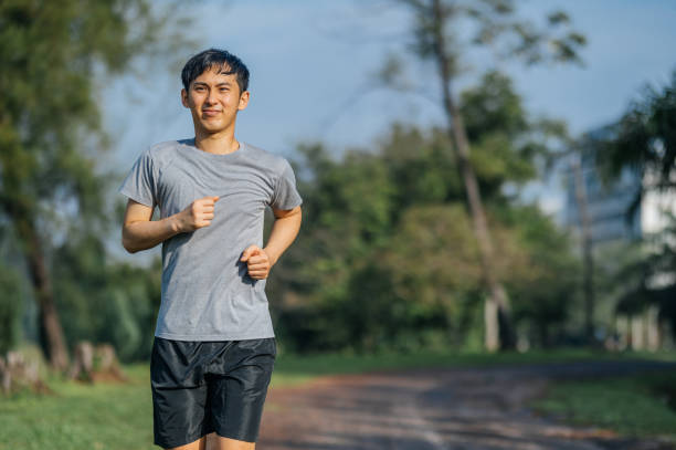 istock Healthy Asian man running in the public park 1356591884
