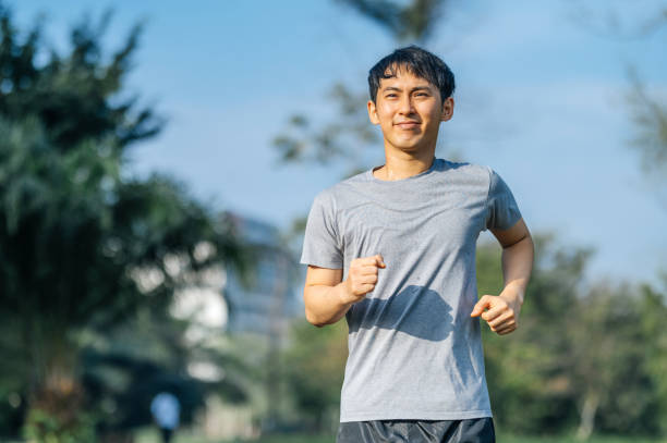 istock Healthy Asian man running in the public park 1356591915